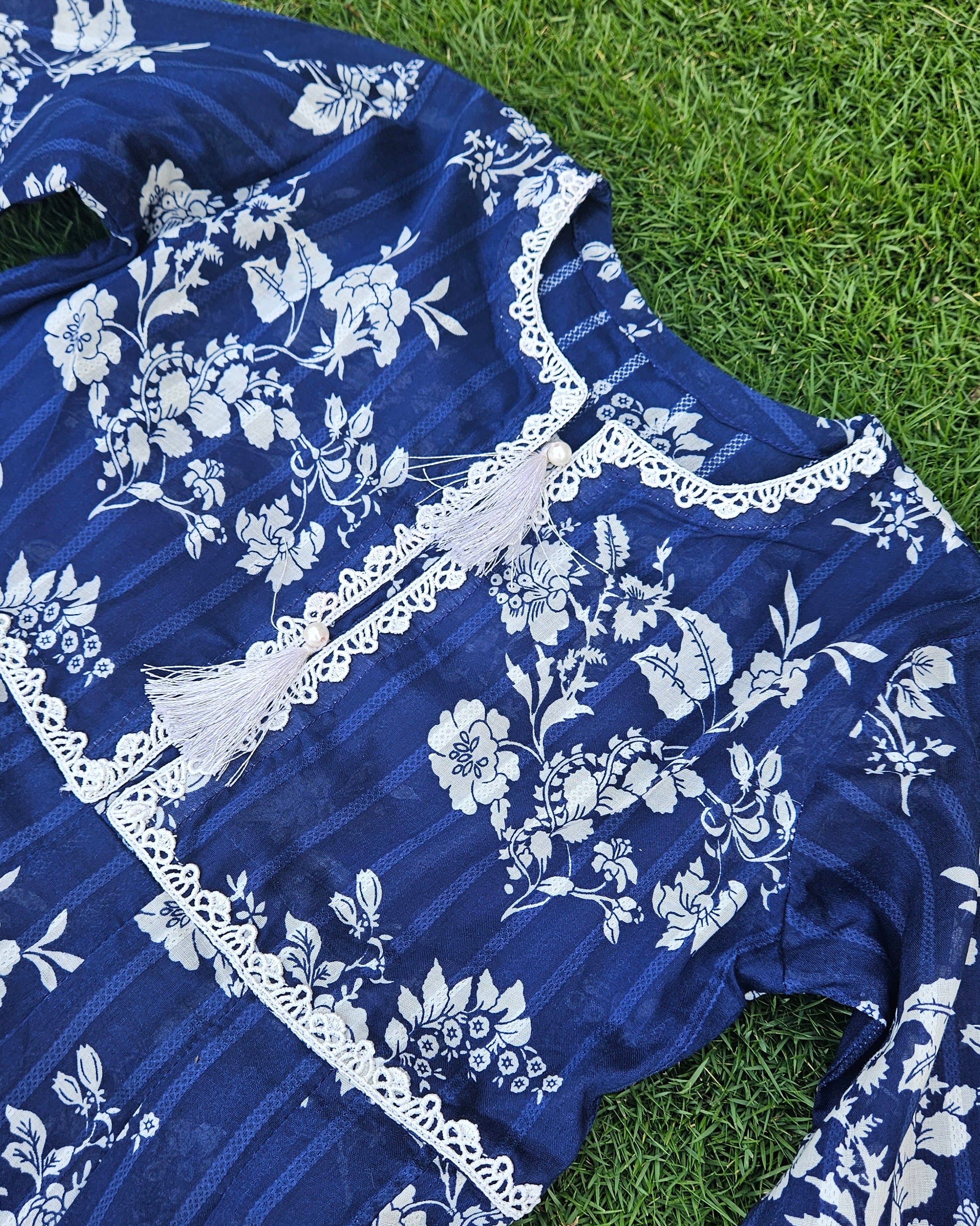Blue floral dress on grass