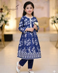 Young girl in a blue floral dress holding a white flower in an elegant indoor setting.